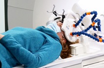  A person lying horizontal having their brain scanned
